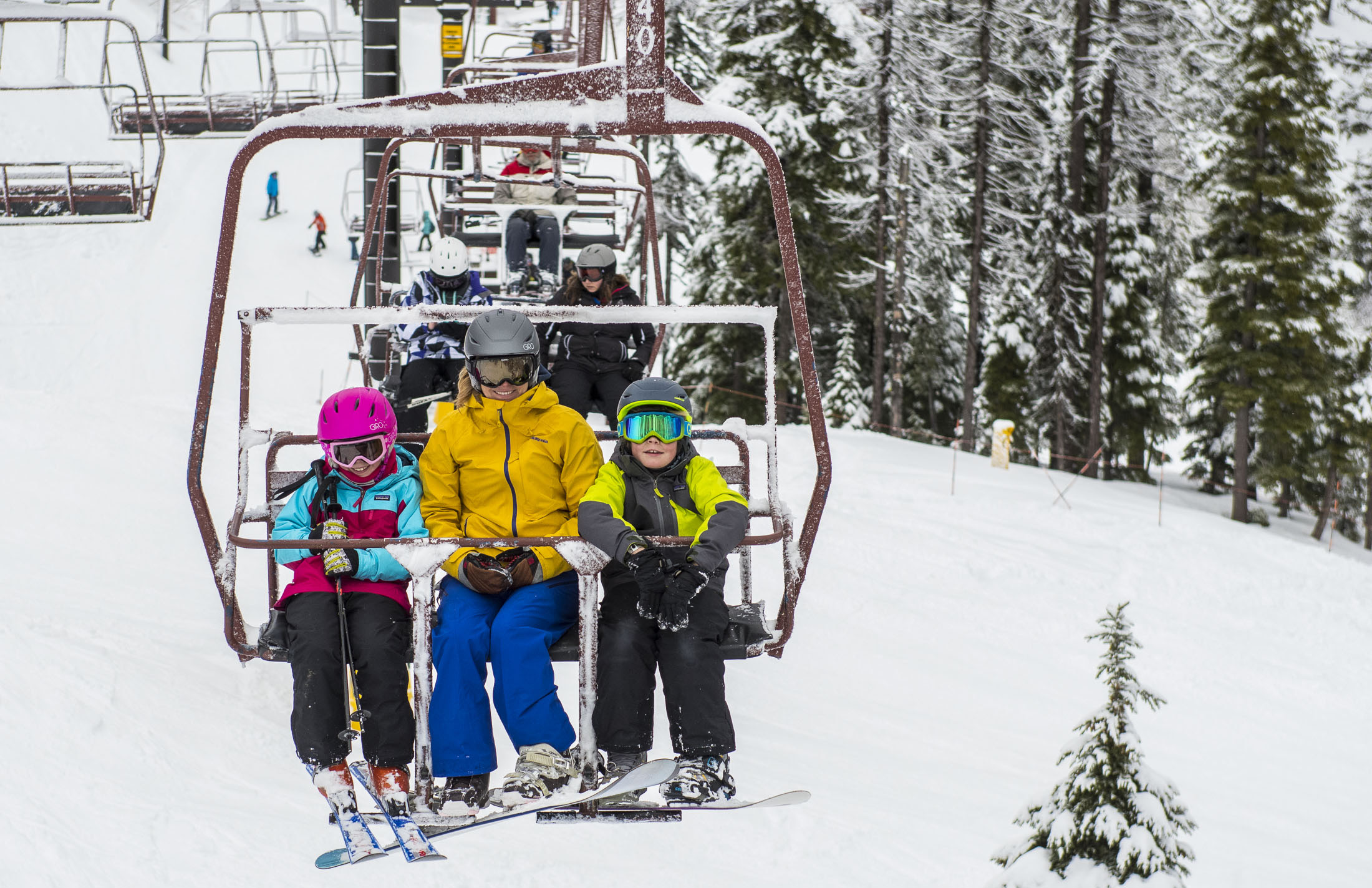 two children and an adult ride the chairlift at Silver Mt. Resort